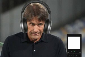 Antonio Conte, allenatore del Napoli, con una faccia corrucciata e delle cuffie in testa